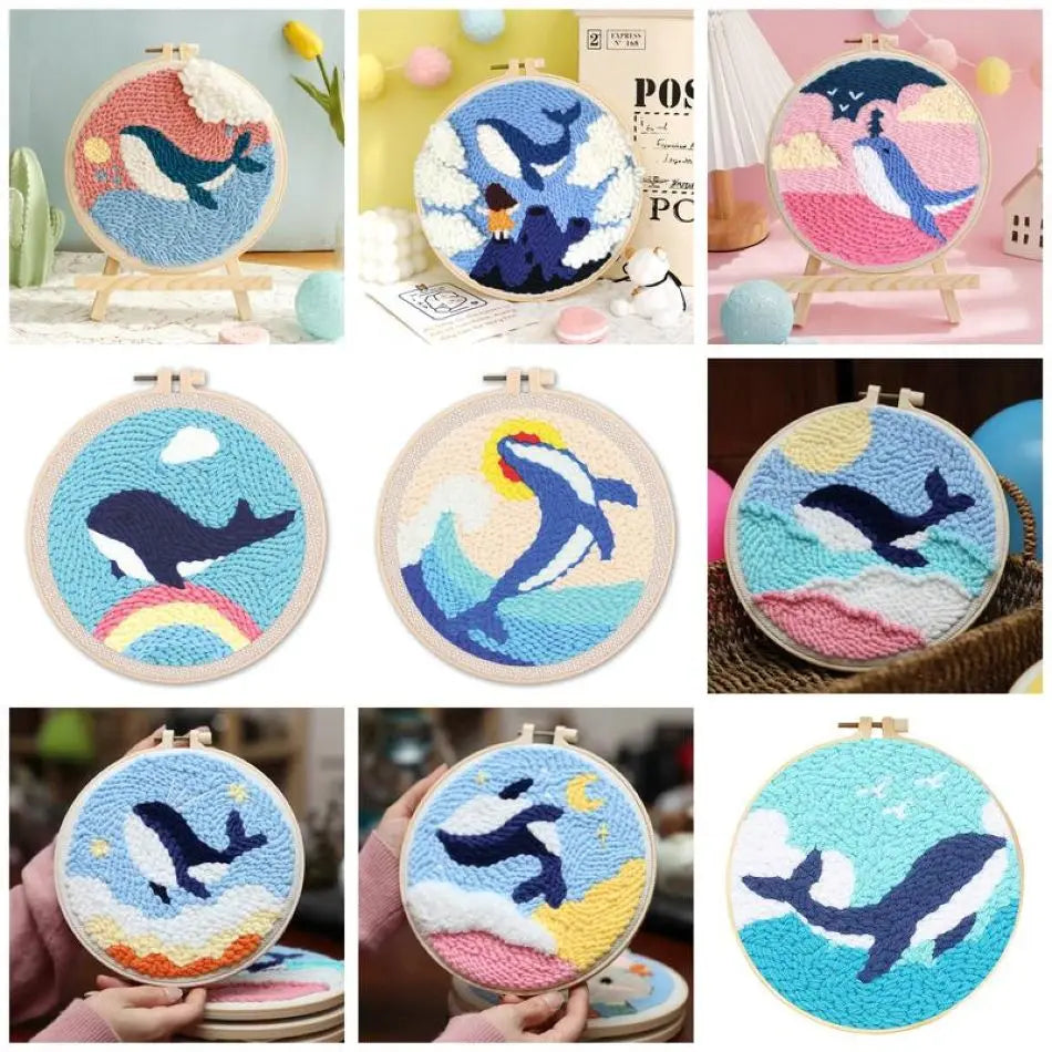 Kit de broderie punch needle pour débutant avec un tambour en bois illustrant une baleine bleue sautant hors de l'eau sur fond de vagues roses et écume blanche.