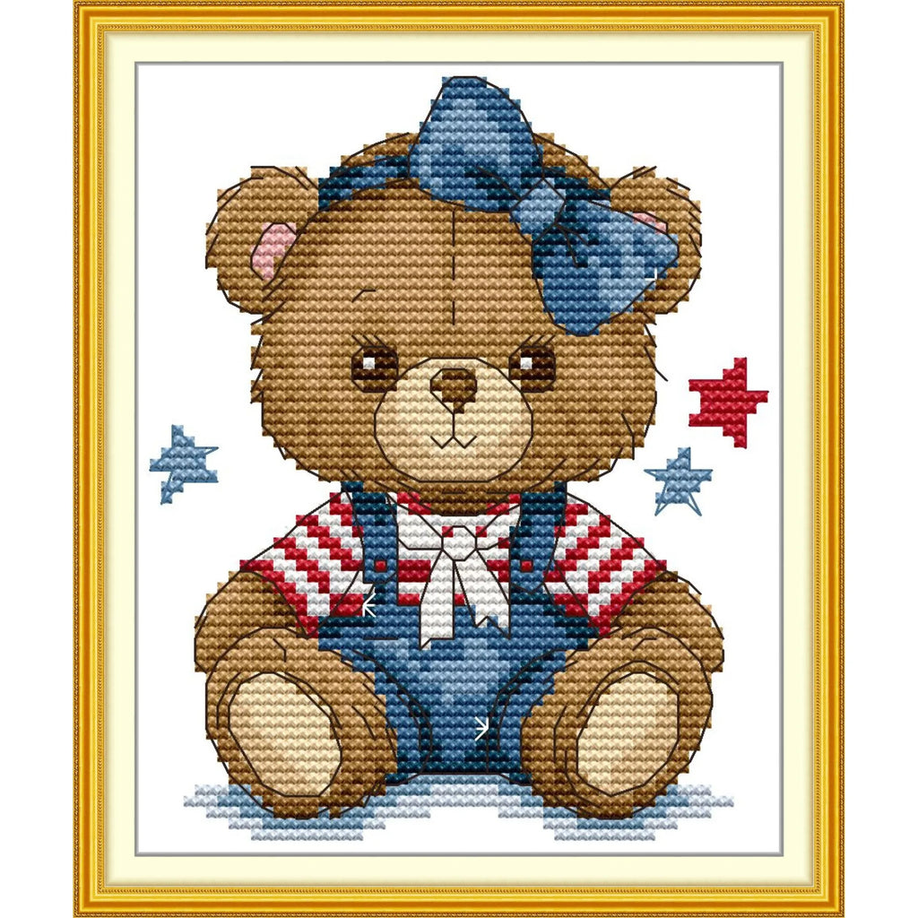Diagramme de point de croix avec un ours en peluche mignon portant une salopette en jean un t-shirt rayé rouge et blanc et un grand nœud bleu sur la tête.
