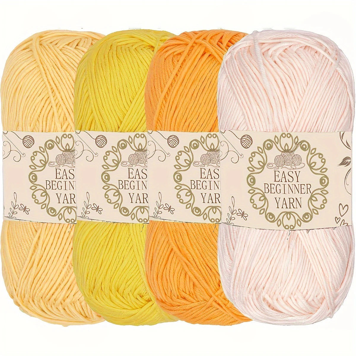 Quatre pelotes de laine de couleurs claires jaune ocre orange pastel et rose nude pour amigurumi