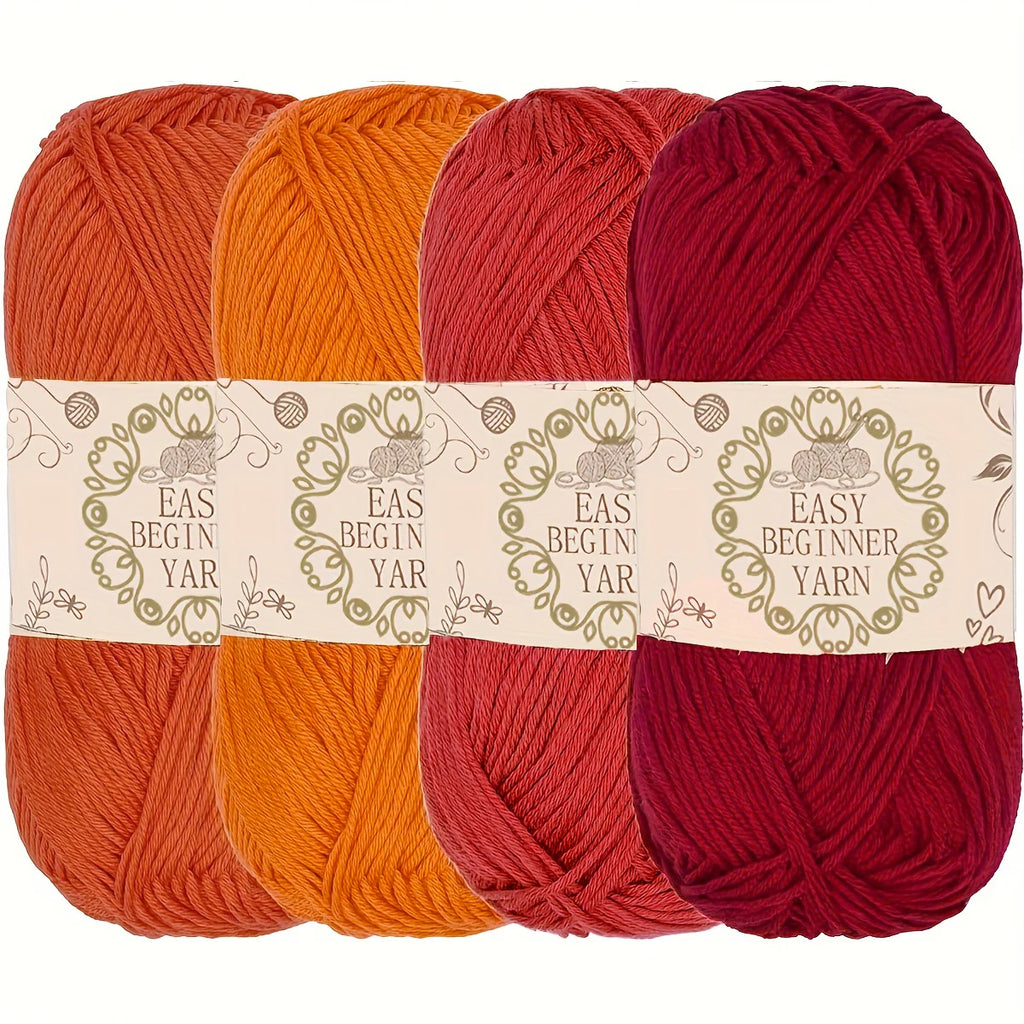 Lot de quatre pelotes de laine pour débutant de couleurs chaudes orange rouge et bordeaux foncé