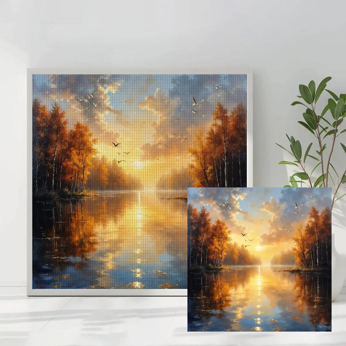Toile point de croix moderne motif coucher de soleil et reflets sur l'eau exposée dans un salon lumineux.