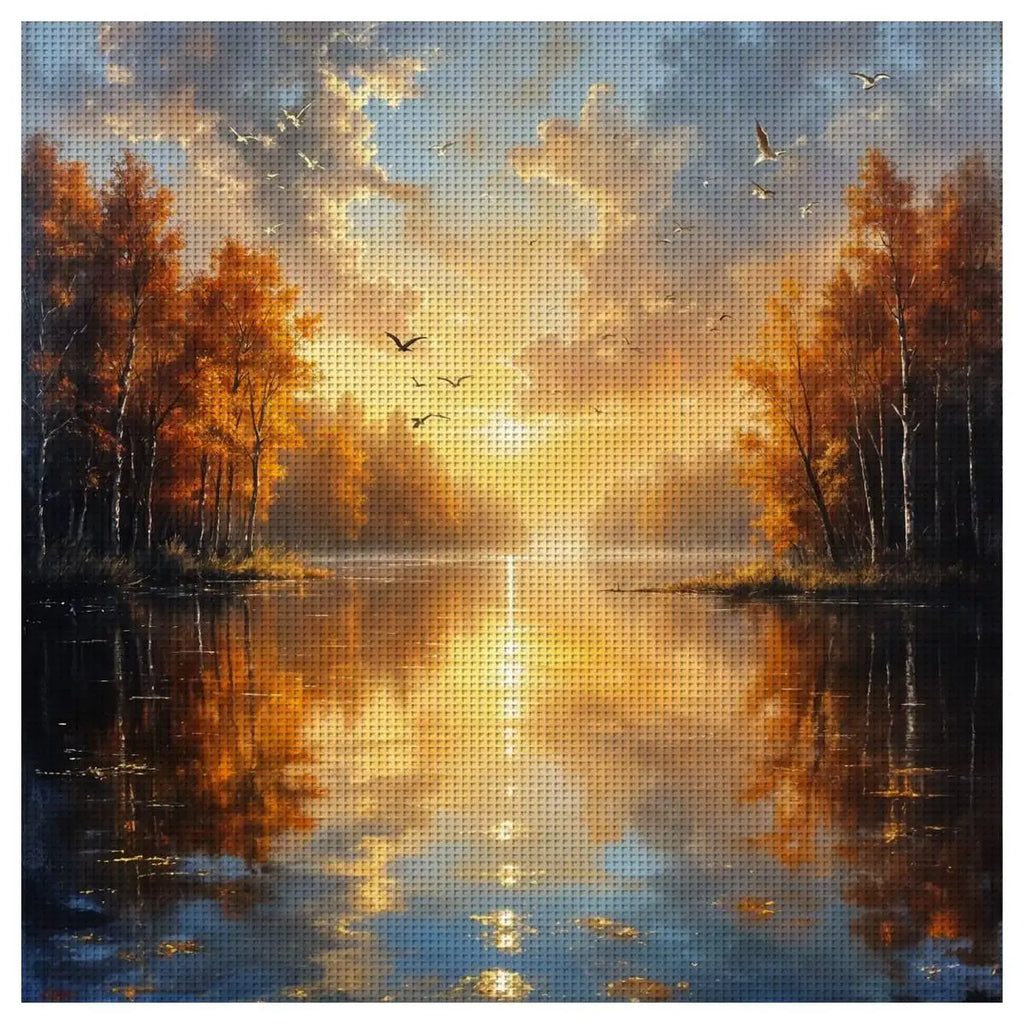 Grille de broderie point de croix paysage de coucher de soleil sur un lac entouré d'arbres d'automne dorés.